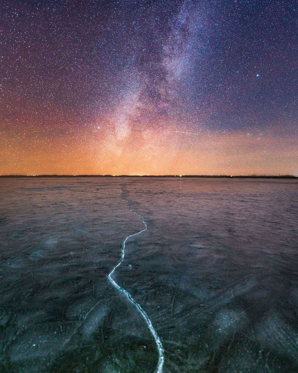 A sky of stars above a lake. Photo by Vincent Ledvina on Unsplash